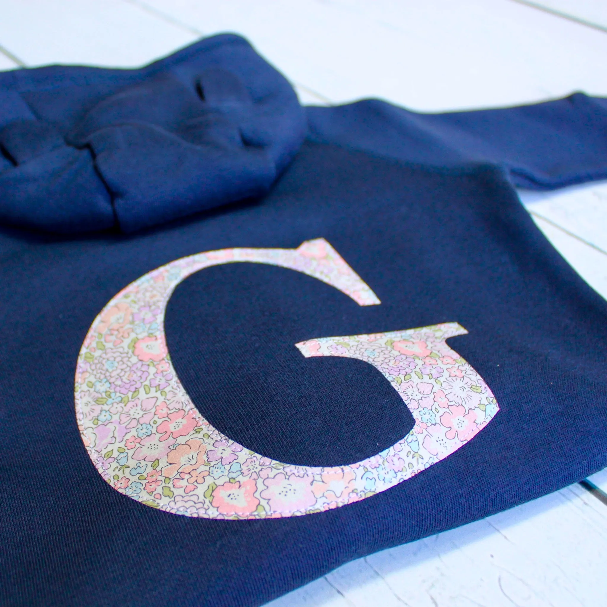 Initial onesie with knee patches