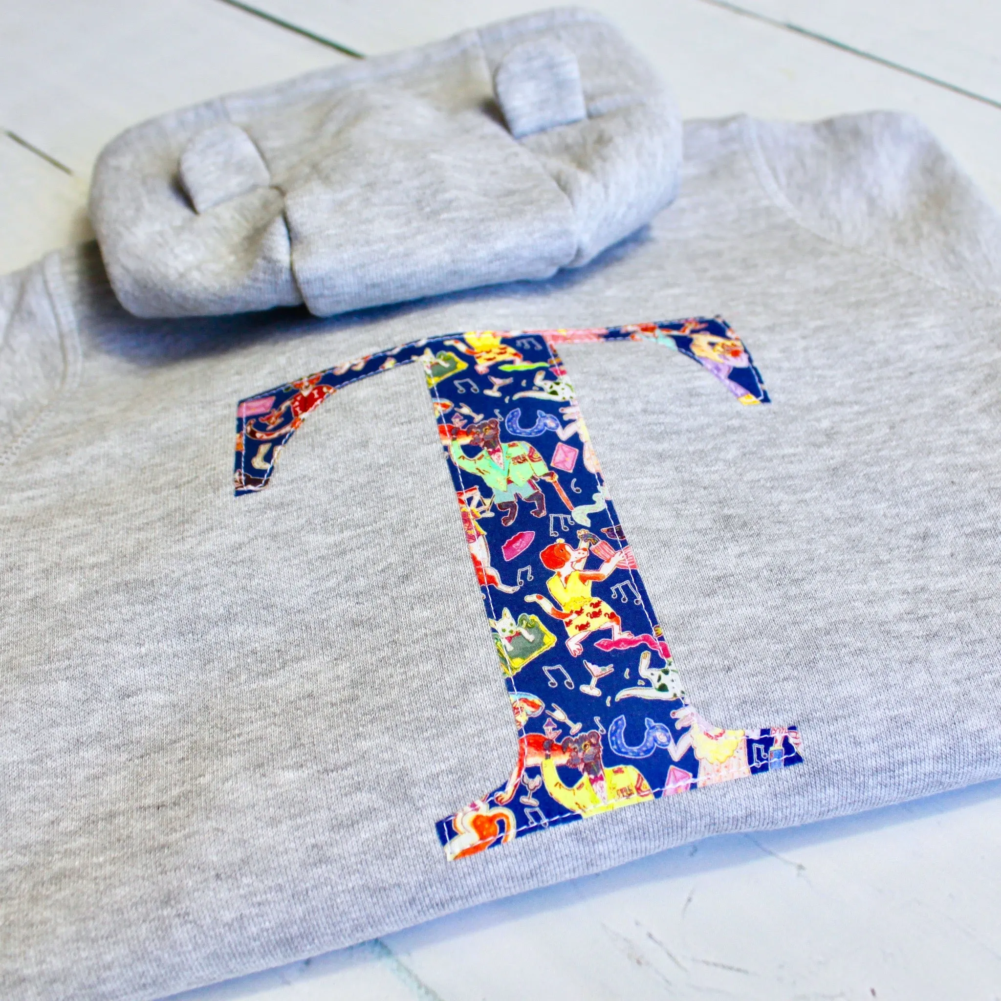 Initial onesie with knee patches